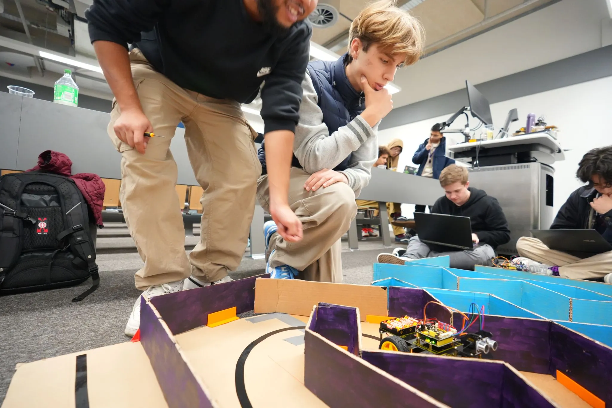 Society members working together on a robotics build